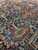 Indigo ground and terracotta tribal medallions seen close up on this antique village weave