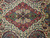 Close-up of the salmon and olive central medallion with checkered panels and small blue blossoms
