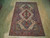 7'10" x 10'2" Sarouk rug displayed on light hardwood floor showing full ivory field and borders