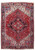 8'1 x 11'7 hand-knotted Persian Heriz rug shown flat with red field and geometric stepped medallion