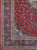 Corner detail showing navy main border, ivory spandrel and flowering vinework on rose red ground