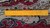 Reverse side with ruler showing tight hand-knotted wool pile and fine cotton foundation weave