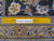 Ruler laid across the weave showing hand-knotted wool knot density of this 10x13 Kashan rug
