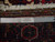 Back of the 8x11 Heriz rug with ruler and Authentic Handmade tag showing knot density