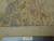 Back of the 8x11 Peshawar rug beside a ruler showing hand-knotted weave and cotton fringe