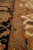 Camel guard stripe separating the black main border from the ivory floral field