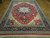Angled floor view of the hand-knotted Heriz Serapi design rug with ivory corner spandrels