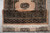 Folded end of the runner showing ivory fringe, end lattice panel and dense wool pile