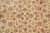 Overhead detail of the symmetrical floral lattice, curling leaves and rosettes across the beige ground