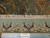 Back of the 8'10" x 12'1" Indian rug beside ruler showing hand-knotted weave density