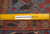 Ruler laid on the hand-knotted wool pile documenting knot density on this authentic handmade Persian rug