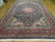 10x14 Indian Oriental rug photographed at an angle, large room size traditional medallion design
