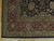 Corner detail showing deep red main border, antique gold guard stripes and ivory cotton fringe