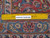 Ruler on the wool pile back showing knots per square inch and authentic handmade weave