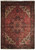 9'4" x 12'3" Persian Heriz rug with salmon field, ivory corner spandrels and navy floral border
