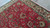Hand-knotted wool pile detail showing palmettes, curled leaves and cream floral shading