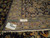 Rug back with ruler and authentic handmade tag showing fine knot density and ivory fringe