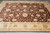 Overhead corner-to-corner view of the large 9x13 brown Ziegler rug with wide ivory border