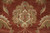 Central palmette motif with ivory core and green acanthus leaves on deep rust ground