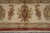 End border close-up with ivory ground, camel guard band and hand-tied cotton fringe