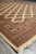 6'11 x 8'5 Bokhara area rug seen from the corner with fringed end and layered borders