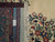 Rug corner folded back with ruler, cotton warps and fringe confirming authentic hand-knotted weave