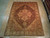 9x12 Persian Tabriz rug displayed flat on light hardwood floor in the Freeport showroom