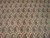 Close-up of hand-knotted paisley boteh motifs with red, green and navy detail on ivory wool
