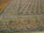 Sky blue and rose floral border corner of this large Persian Kerman wool rug