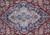 Close-up of navy and ivory lobed medallion with pink roses on ruby red field
