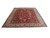 9'9" x 12'3" Persian Tabriz area rug angled, showing deep red field and cream borders