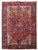 Full view 8'1" x 11'6" Persian Heriz rug with navy medallion on deep red field