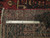 Back of the rug with ruler measuring knot density, cotton foundation and hand-knotted wool weave