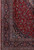 Corner detail showing navy main border, light blue guard stripes and rose floral wool pile