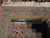 Reverse of the rug with a ruler across the back measuring knot density near border