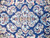 Close-up of wool pile showing detached floral sprays, palmettes and vinery on deep navy ground