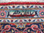 Woven signature cartouche in the light blue guard border of this signed Persian Kashan rug