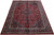 Angled floor display showing deep red field, navy cornerpieces and dense all-over floral vinework