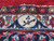 Woven signature cartouche in the ivory border of this signed Persian Kashan workshop rug