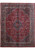 Full view of 10x13 red Persian Kashan rug with navy medallion and ivory floral border