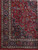 10 by 13 Kashan rug corner detail with ivory guard stripes and paisley main border