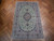 6'4" x 9'8" Persian Nain wool and silk rug displayed on herringbone parquet wood floor