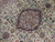 Close-up of the navy and cream lobed medallion with silk highlighted arabesques on mint field