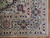 Corner detail showing ivory main border, palmettes, sky blue guard stripes and tight weave
