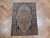3'4" x 4'7" antique Persian rug displayed on herringbone parquet floor, blue and pink florals