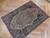 Angled view of the 3x5 Persian Farahan rug showing navy border and salmon center medallion