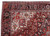 Corner detail showing ivory spandrel, palmettes and the blue black main border of this hand-knotted rug