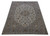 Angled full view of cream wool Persian rug showing all over floral field and palmette border