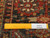 Back of the 8x12 Heriz rug with ruler, showing hand-knotted wool pile and cotton foundation