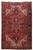 8'1" x 12'3" Persian Heriz rug with red field, navy medallion and ivory corner spandrels
